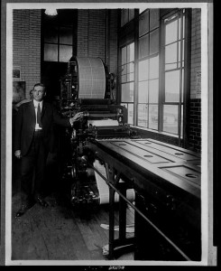 Benjamin Stickney and the rotary printing press that bears his name, circa 1920.